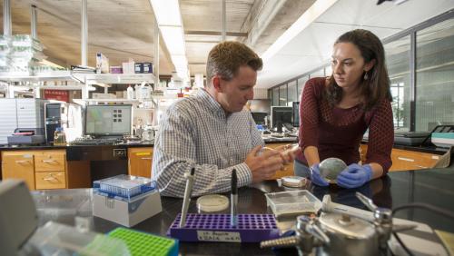 Professor Bromage assists student in lab