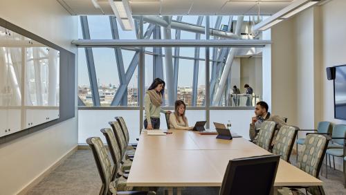 Students work in conference room on campus