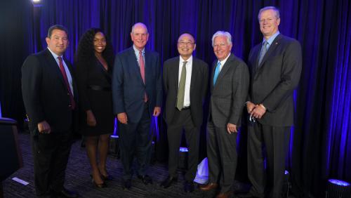 Chairman Rob Manning, Trustee Chioma Okwara, Chancellor Michael Collins, Dr. Gerald Chan, President Marty Meehan and Gov. Charlie Baker at the announcement of the Chan gift