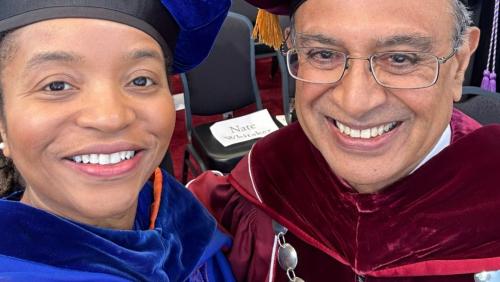 Dr. Nefertiti Walker and UMass Amherst Chancellor Kumble Subbaswamy at UMass Amherts's 2023 commencement taking a selfie together, smiling.