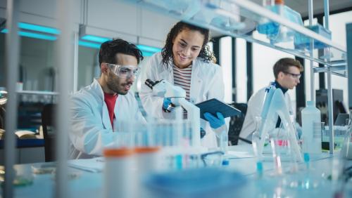 A man and woman in a medical lab working together.